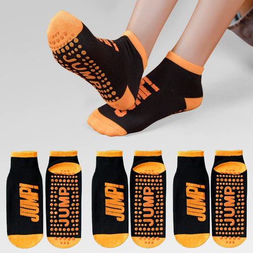 Black and orange socks with 'JUMP!' branding on a gray background